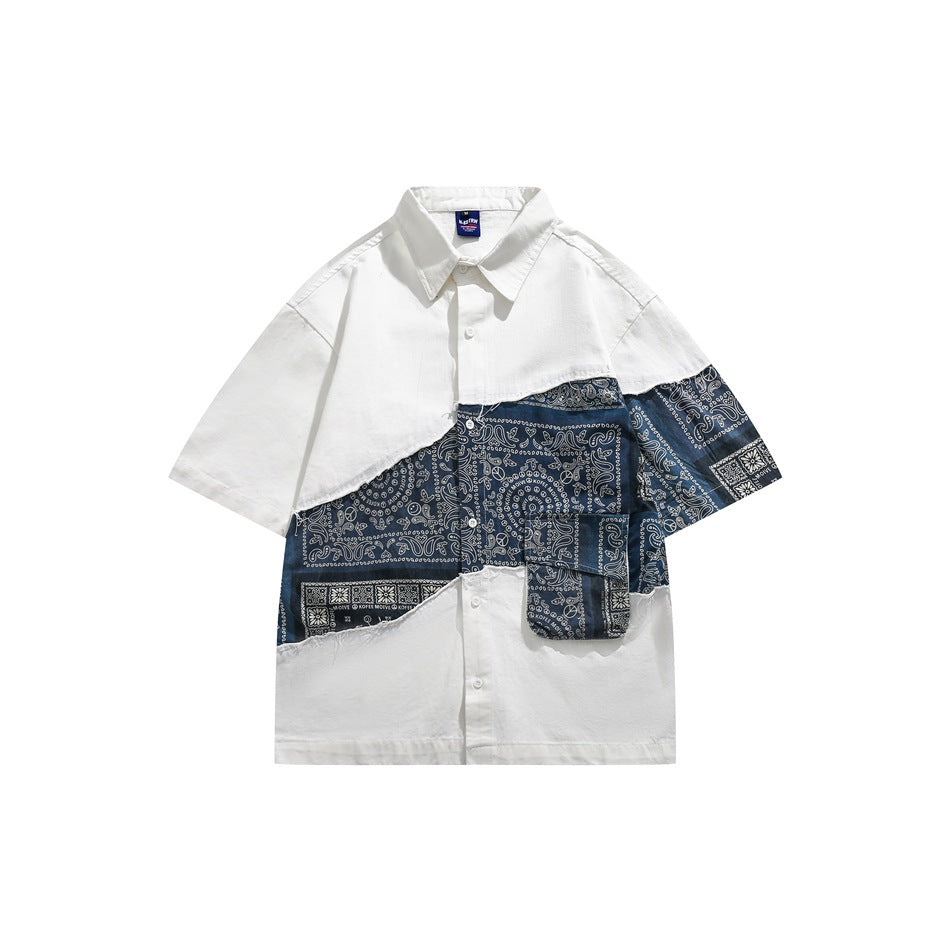White short-sleeve button shirt with diagonal navy bandana-paisley patchwork panel and flap pocket, front view