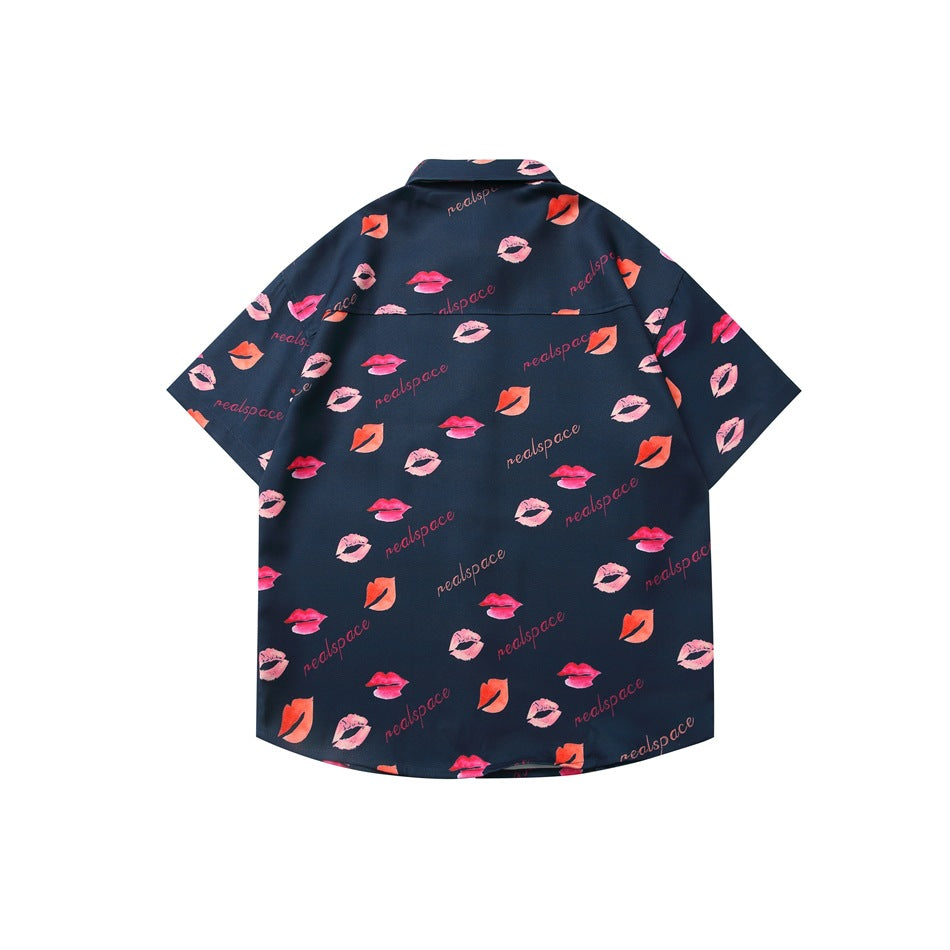 Back view of a dark navy short-sleeve button-up shirt patterned with pink and coral lipstick prints and lettering.