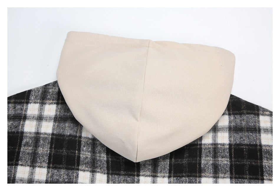 Close-up of a cream hood against the black, gray, and cream plaid back of a garment.