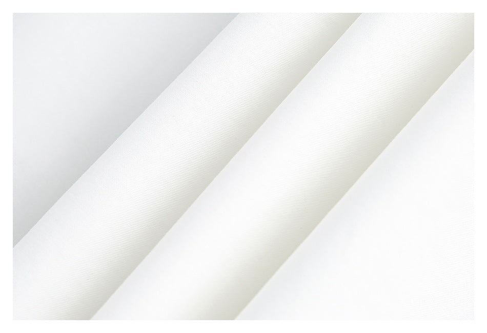 Close-up of white fabric arranged in diagonal folds, showing a fine woven texture.