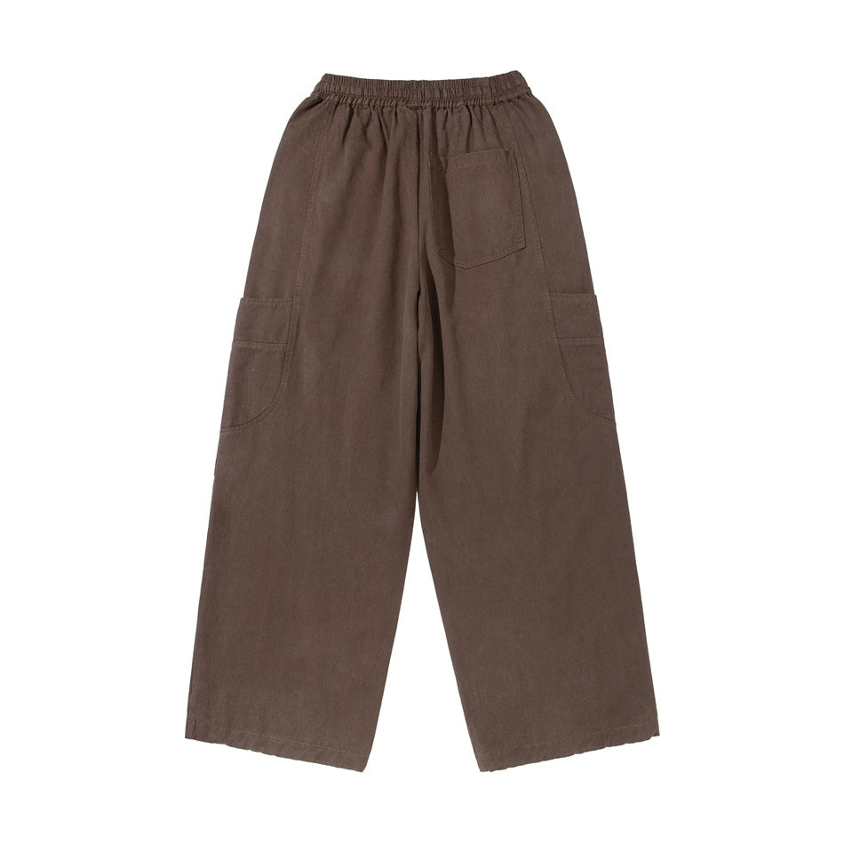 Back view of dark brown wide-leg pants with an elastic waistband, one back patch pocket and large side pockets.