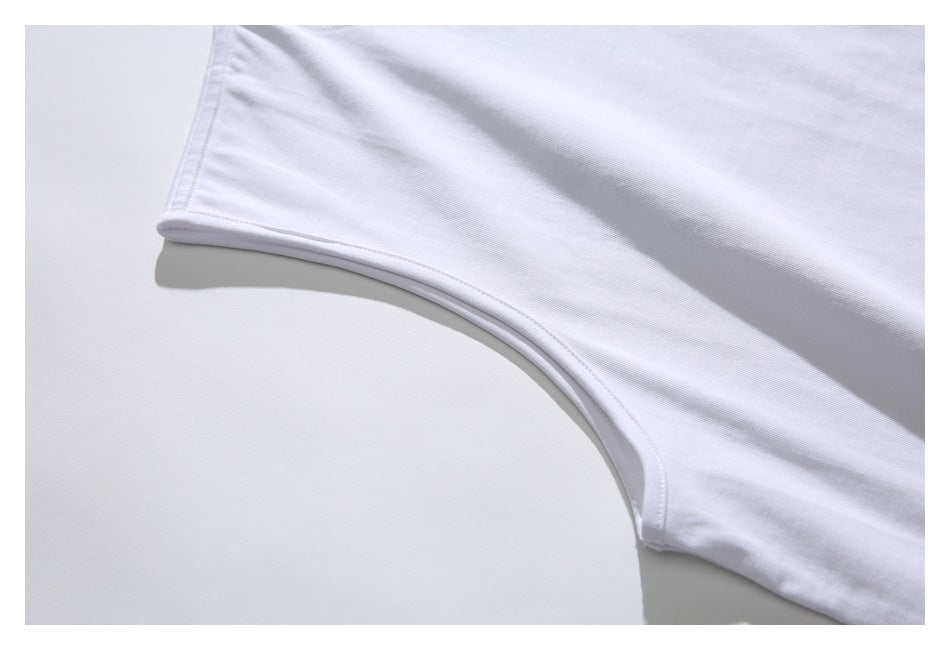 Close-up of the white sleeveless shirt's armhole seam and curved edge.
