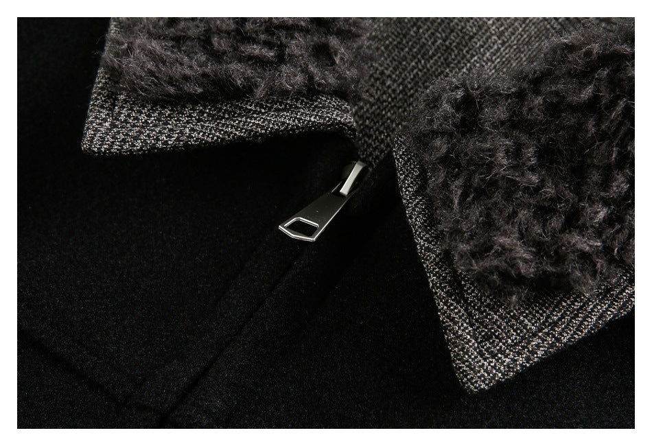Close-up of a black garment with a silver zipper and fuzzy dark trim over a gray-speckled woven edge.