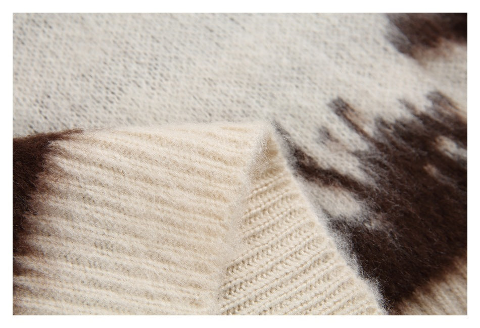 Close-up of a cream ribbed sleeve cuff against the sweater's brown-and-cream pattern.