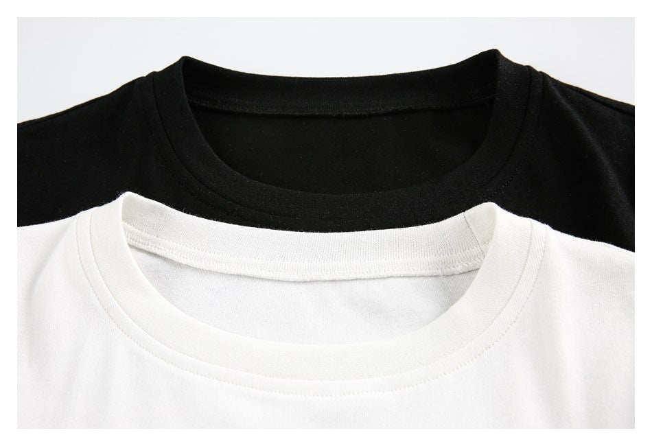 Close-up of the crew necklines of black and white T-shirts.