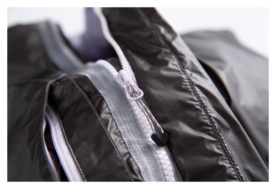 Close-up of a pale zipper and cord pull on a black jacket, with textured gray trim.