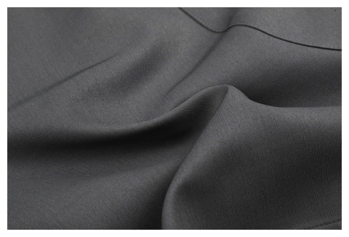 Close-up of charcoal gray fabric showing its fine texture and draped folds.