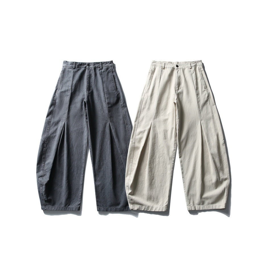 Two pairs of wide-leg trousers shown from the front: one charcoal gray and one light beige, both with front pleats.