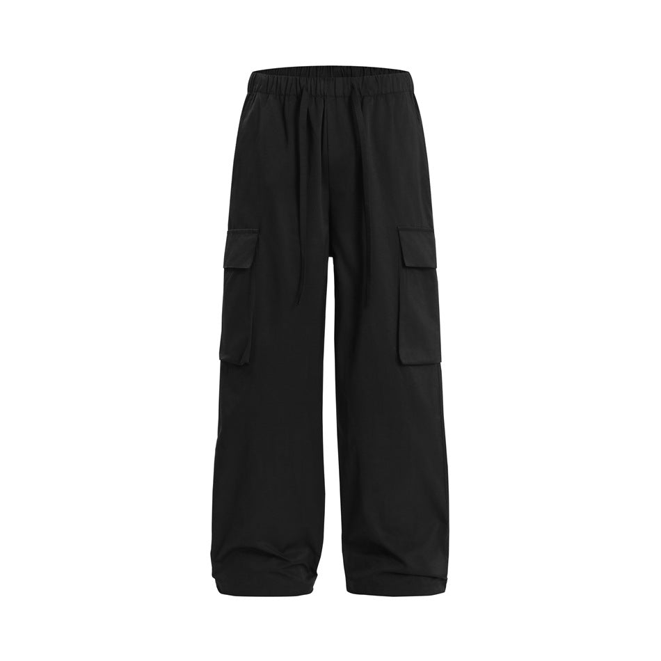 Black wide-leg cargo pants with elastic drawstring waist and large flap pockets, flat front view