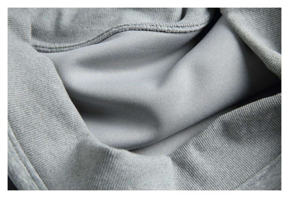 Close-up of the gray garment interior, showing smooth fabric, seams, and ribbed trim.