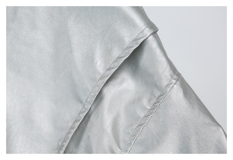 Close-up of a silver garment panel and diagonal stitched seam.