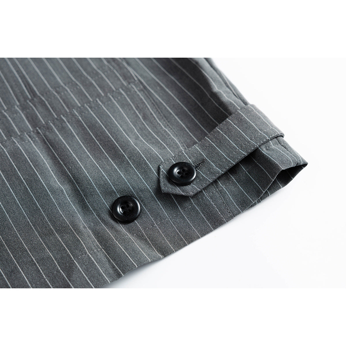 Close-up of a charcoal pinstripe sleeve cuff with two black buttons.