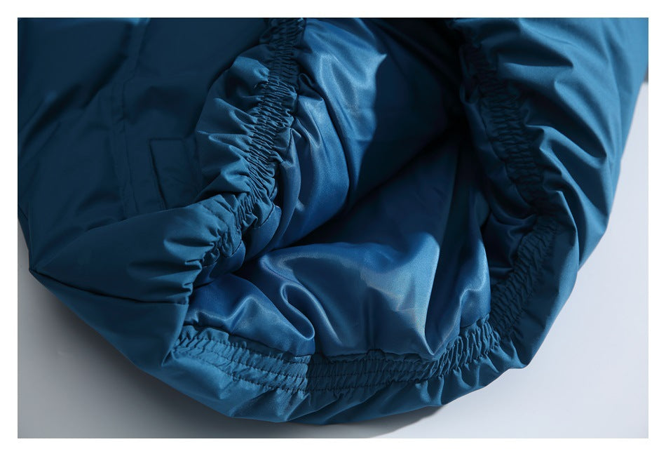 Close-up of gathered elastic edging and seams on the teal-blue jacket.