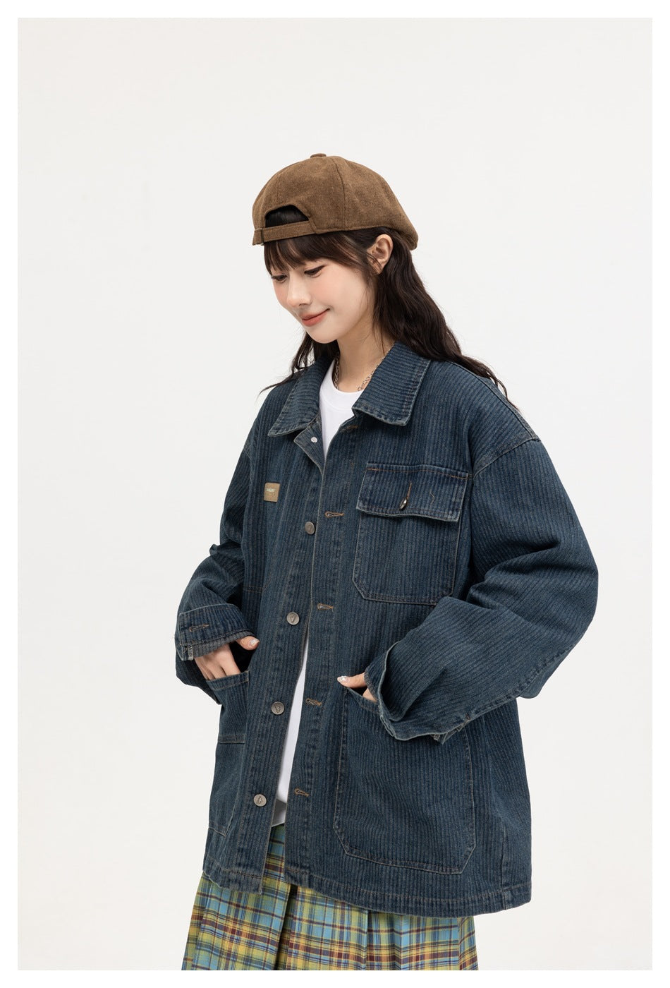 Model wearing an oversized dark blue denim jacket with a buttoned chest pocket and large front pockets.