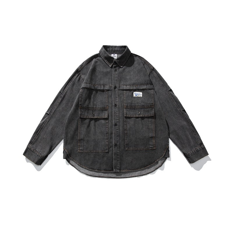 Front flat lay of faded black denim jacket with snap flap chest pockets, curved hem and woven chest label