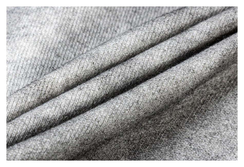 Macro view of heather gray knit fabric folded to show its textured surface.