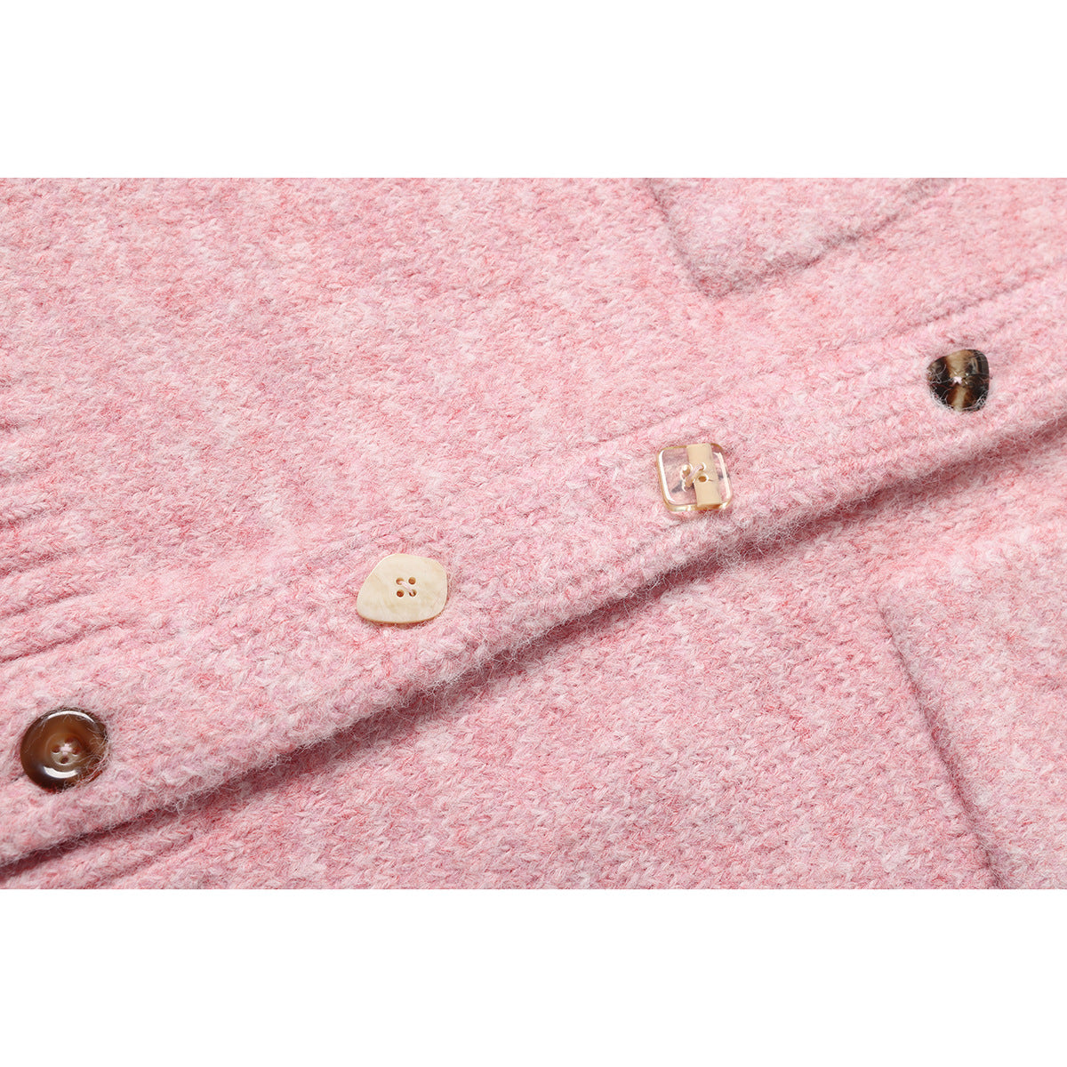 Close-up of a pink fuzzy knit garment front with several contrasting buttons and a folded placket.