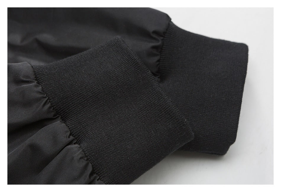 Close-up of a black jacket sleeve with a wide ribbed cuff.