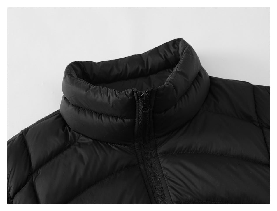 Close-up of the black vest's padded high collar and upper front zipper.