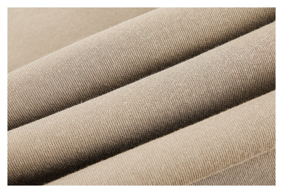 Macro close-up of the textured beige fabric folded into several ridges.