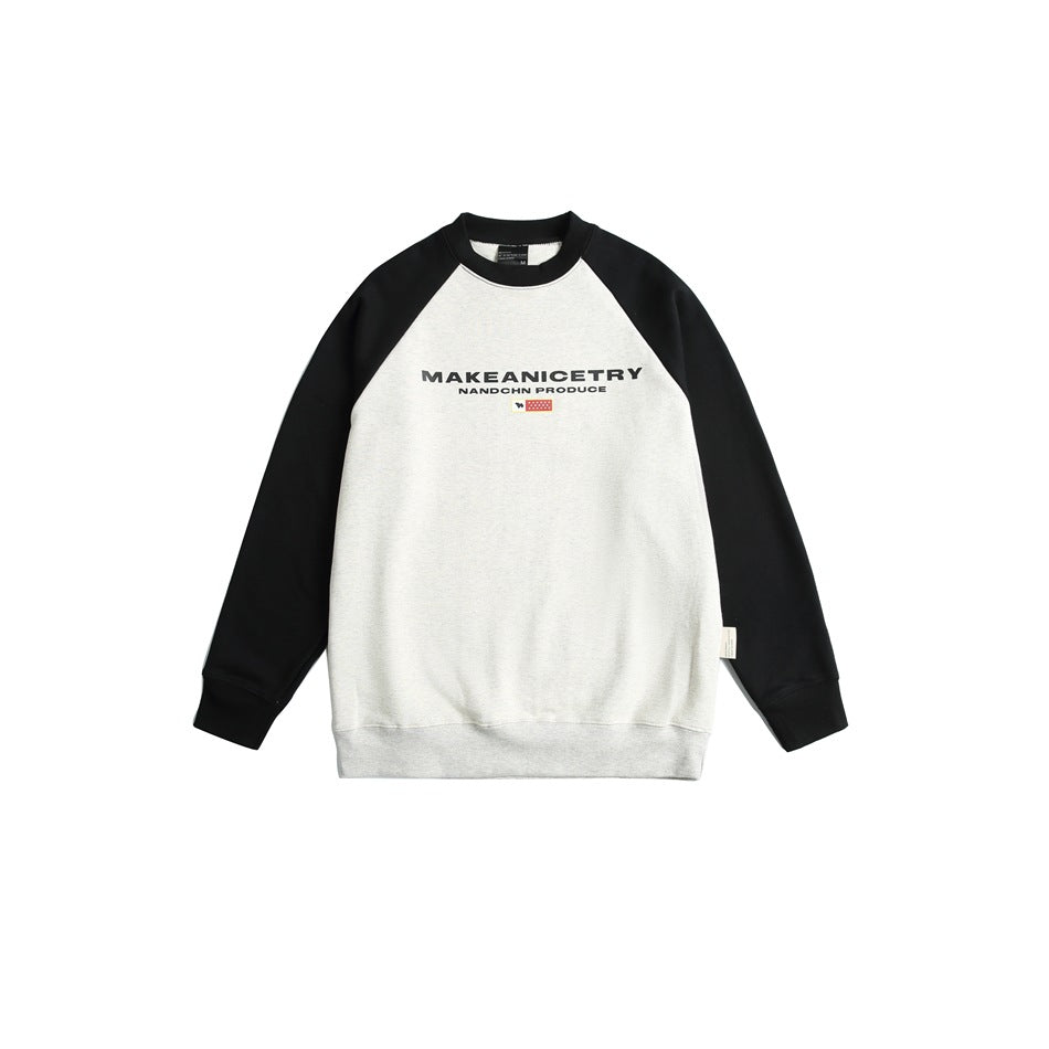 Off-white crewneck sweatshirt with black raglan sleeves and collar, chest print and small flag graphic, flat front view