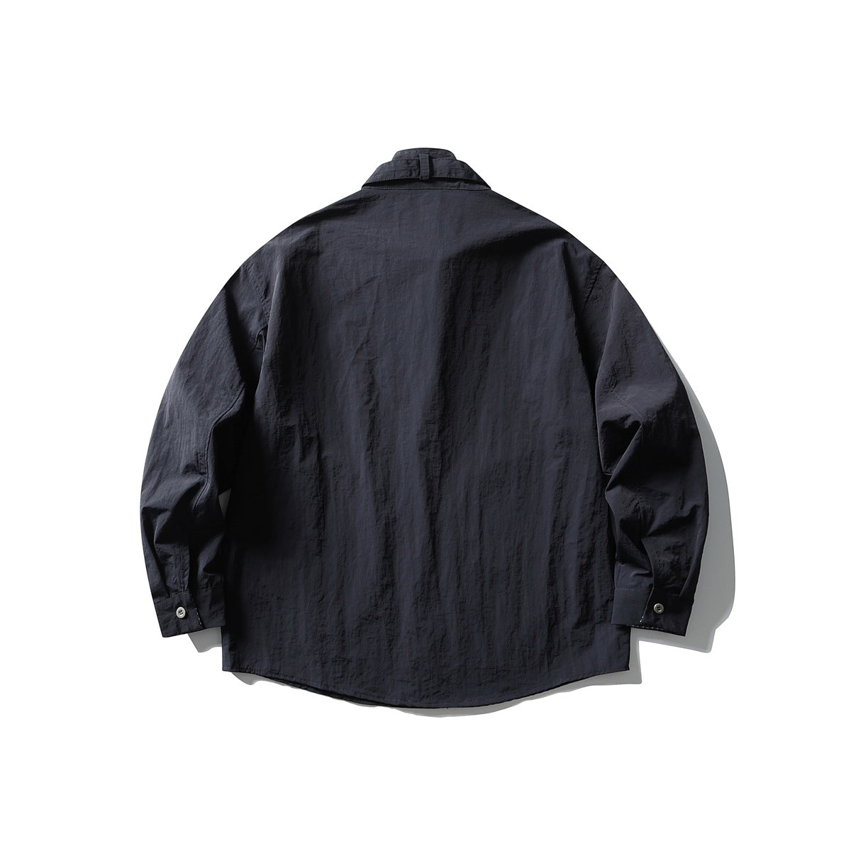 Back view of a dark charcoal long-sleeve button-up shirt with a curved hem and buttoned cuffs.