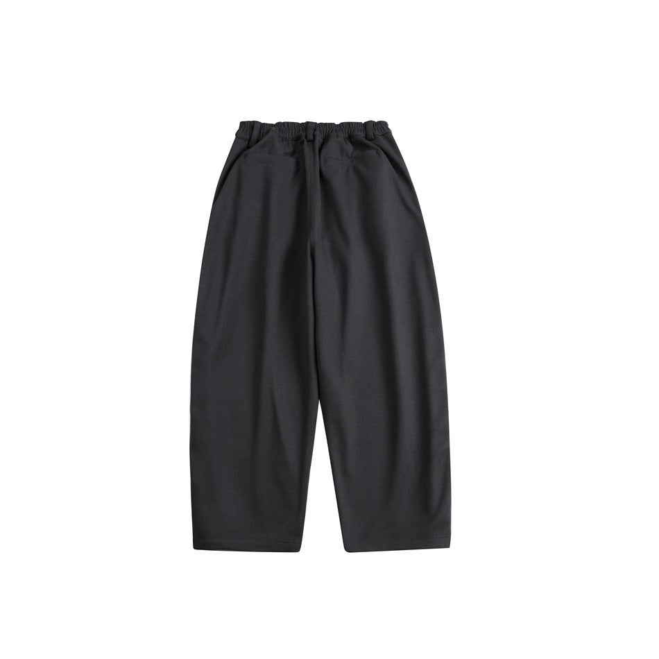 Black wide-leg trousers shown from the front, with an elastic waistband and side pockets.