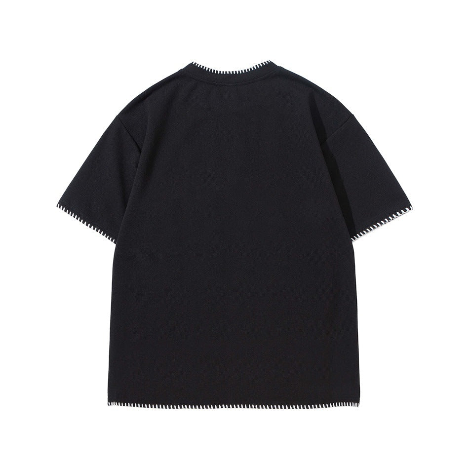 Back view of black short-sleeve tee with white whipstitch trim at neckline, sleeve hems and bottom hem