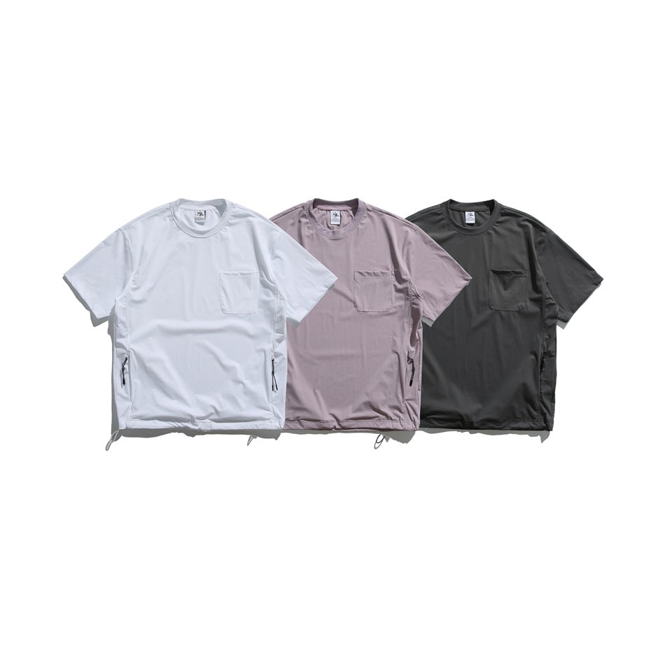 Three short-sleeve crew-neck shirts with chest pockets in white, mauve, and charcoal.