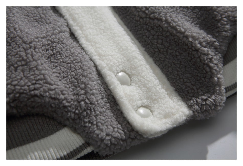 Close-up of two white snaps on the cream front placket between gray textured panels.