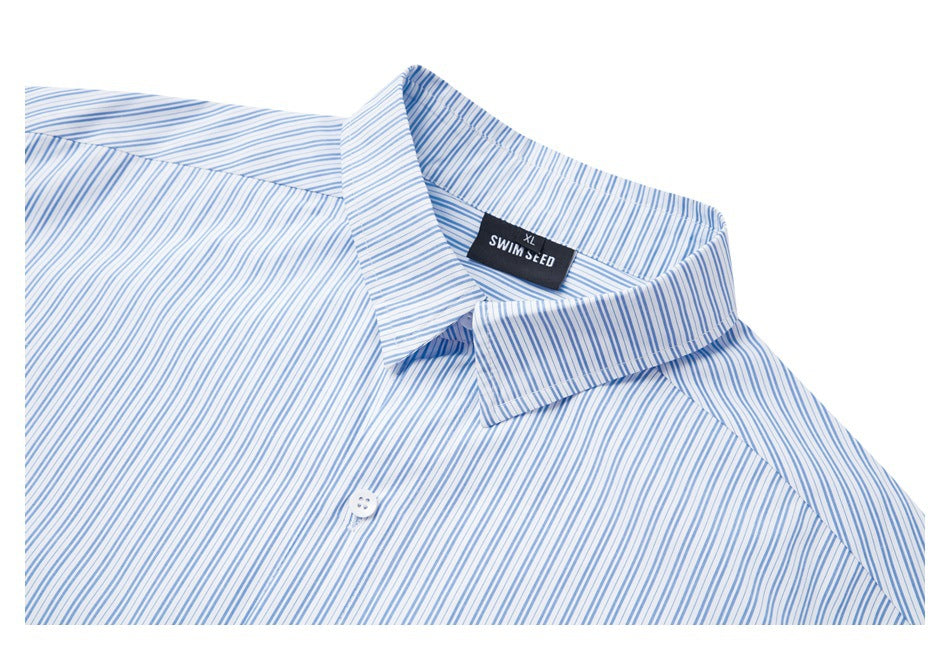Partial front view of a white shirt with fine blue stripes, pointed collar, button, and black neck label.
