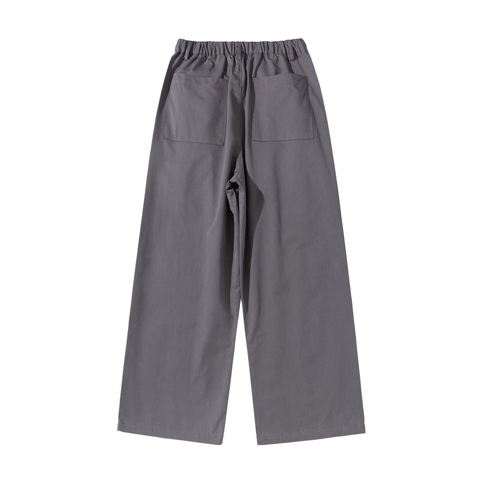 Full back view of charcoal gray wide-leg trousers with an elastic waistband and two patch pockets.