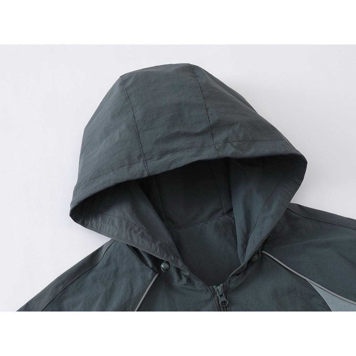 Close-up of a dark gray hooded jacket showing the hood, front zipper, and snap fasteners.