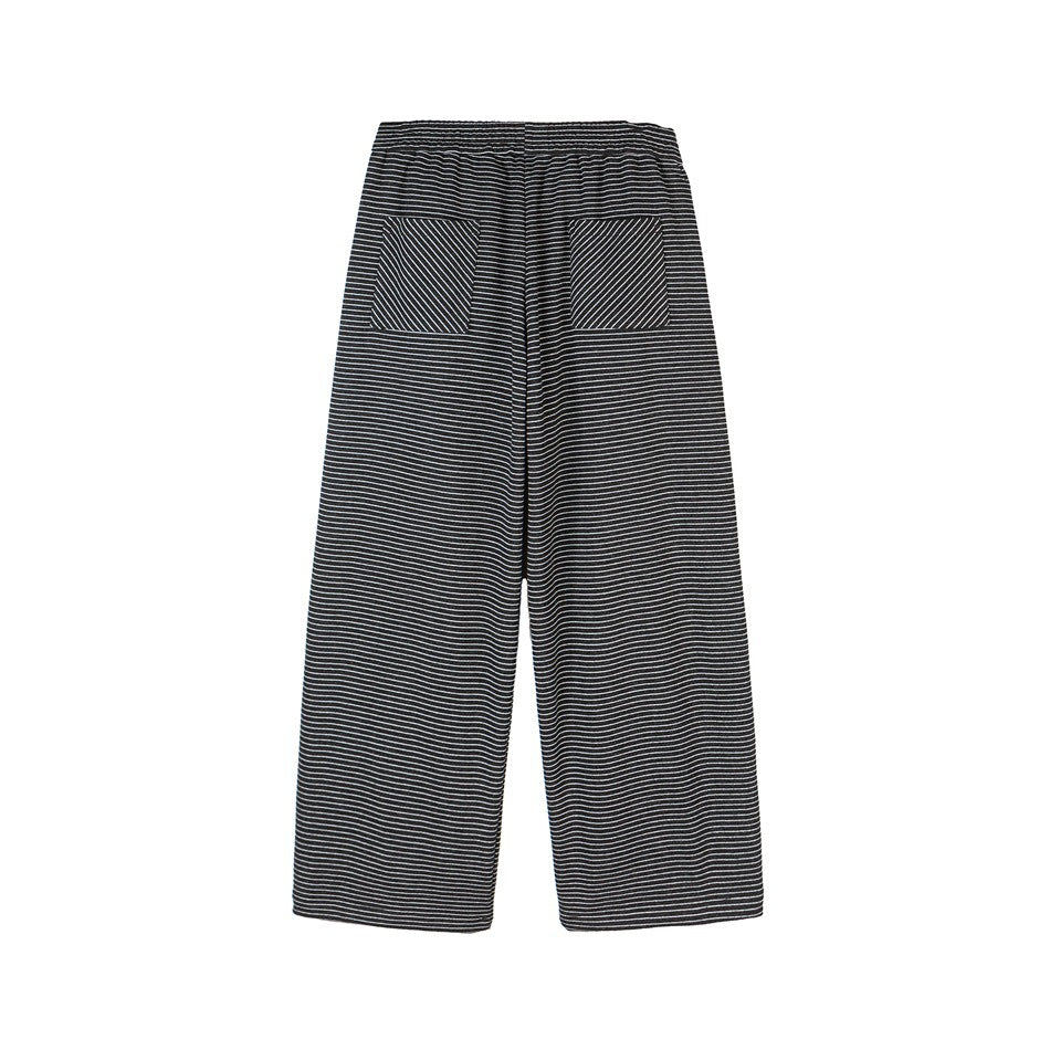 Back view of loose black trousers with thin white horizontal stripes and two diagonal-striped back pockets, shown flat.