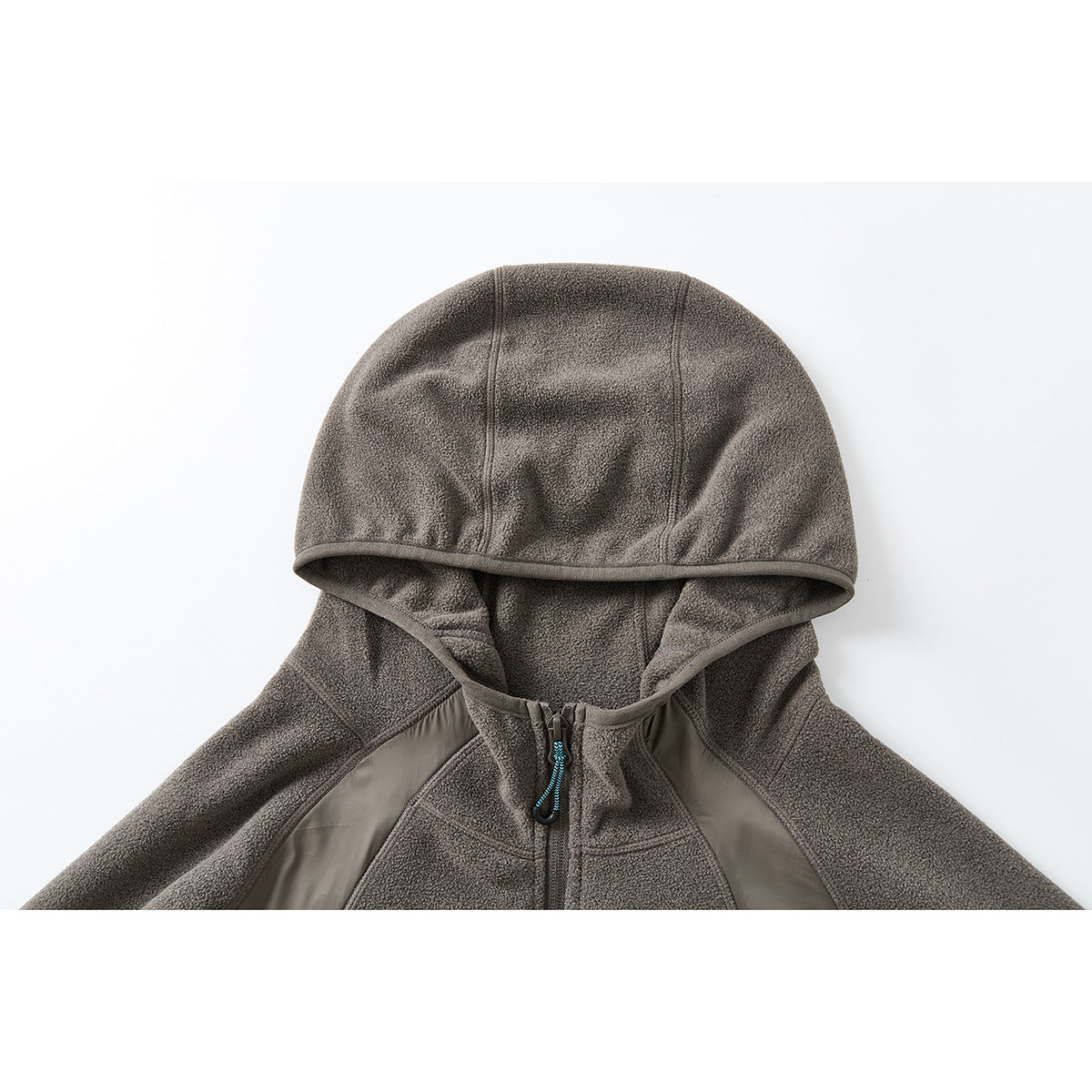 Close-up of a taupe-gray hooded jacket showing the hood, front zipper, and contrasting panels.