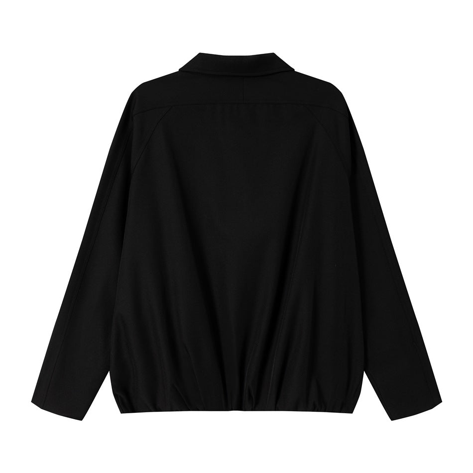 Back view of a black jacket with a pointed collar, long sleeves, and gathered hem.