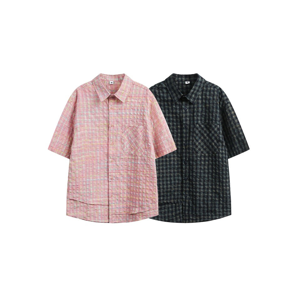 Two short-sleeve plaid button-up shirts shown side by side in pink and dark navy-green colorways.