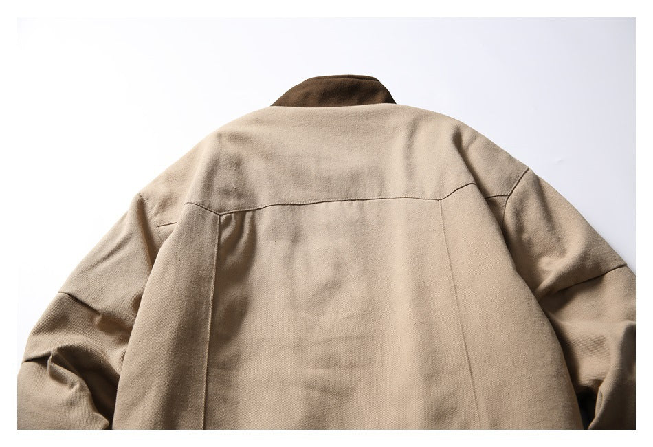 Back view of a tan jacket with a dark brown collar and curved upper-back seam.
