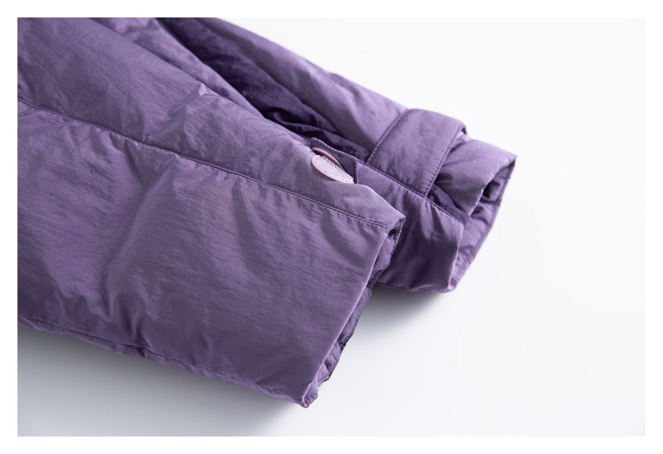Close-up of the purple jacket’s cuff and a small oval detail near the seam.
