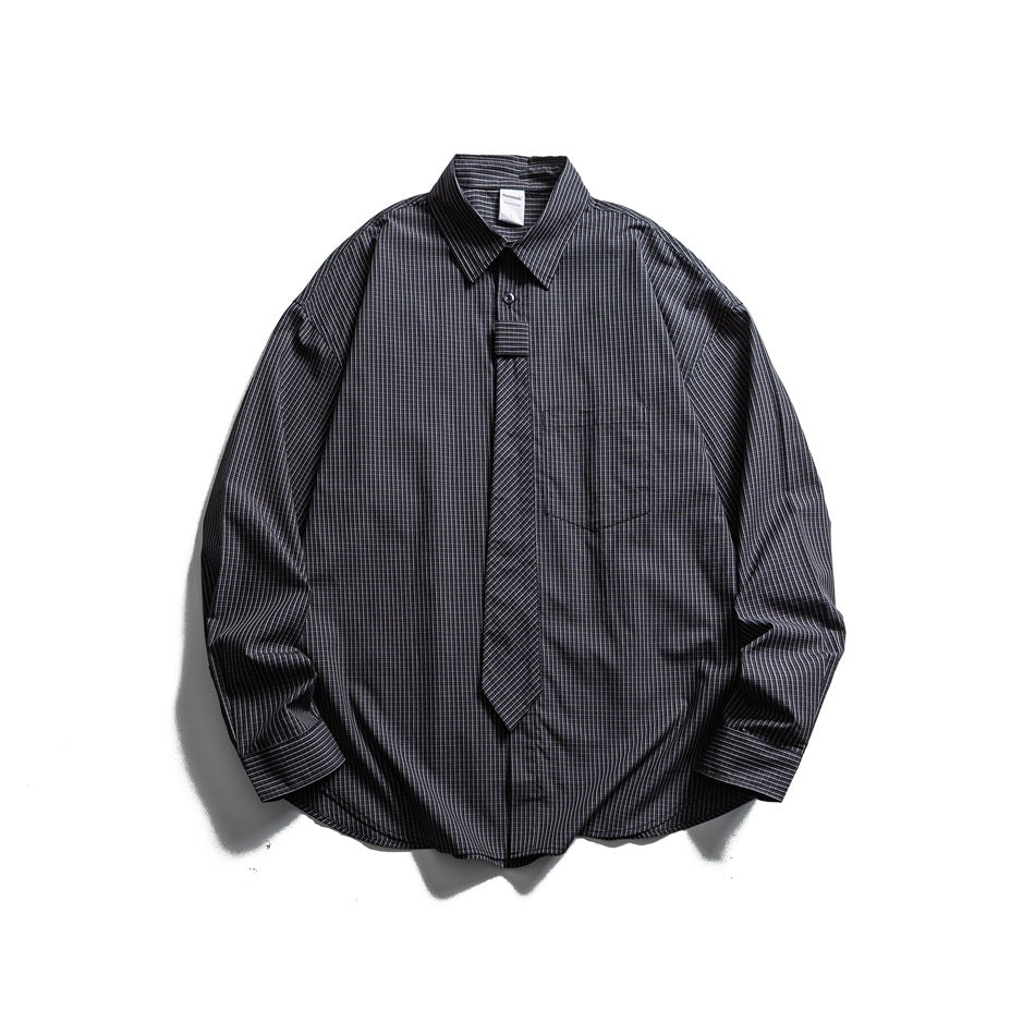 Front view of a dark charcoal plaid long-sleeve shirt with a pointed collar, chest pocket, and matching tie.