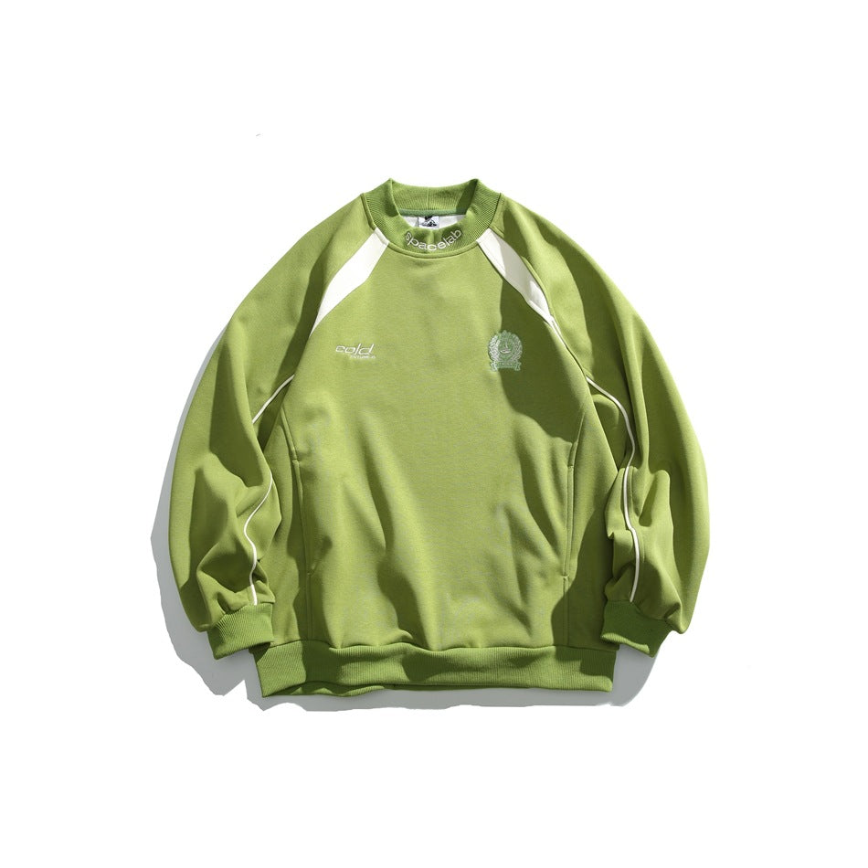 Apple green crewneck sweatshirt with cream raglan shoulder panels, sleeve piping, embroidered chest crest and ribbed trims