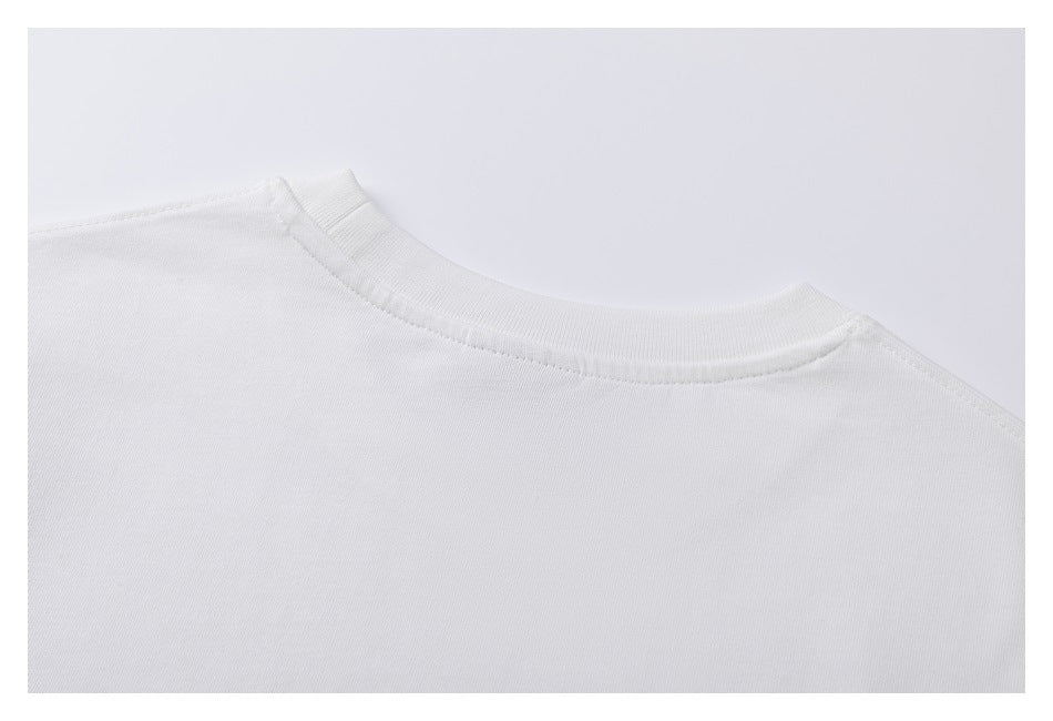 Close-up of the white T-shirt’s ribbed crew neckline and shoulder seams.