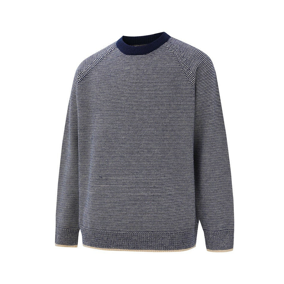 Navy and white striped crew-neck raglan sweater with navy collar and cream-trimmed ribbed cuffs and hem, angled front view