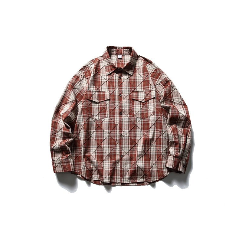 Red and cream plaid long-sleeve shirt with diamond stitched lines, flap chest pockets and button front, laid flat