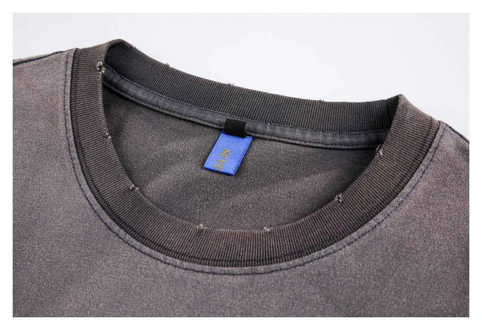Close-up of the gray T-shirt's ribbed crew neck and inner label.