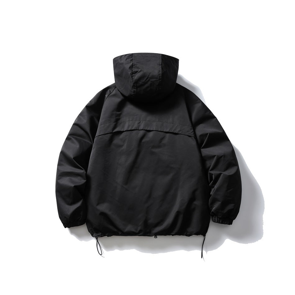 Back view of a black hooded jacket with a curved back seam, elastic cuffs and adjustable hem drawcords.