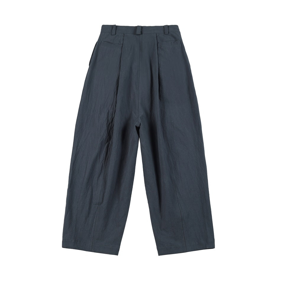 Back view of dark slate-blue wide-leg trousers with belt loops and two rear pockets.