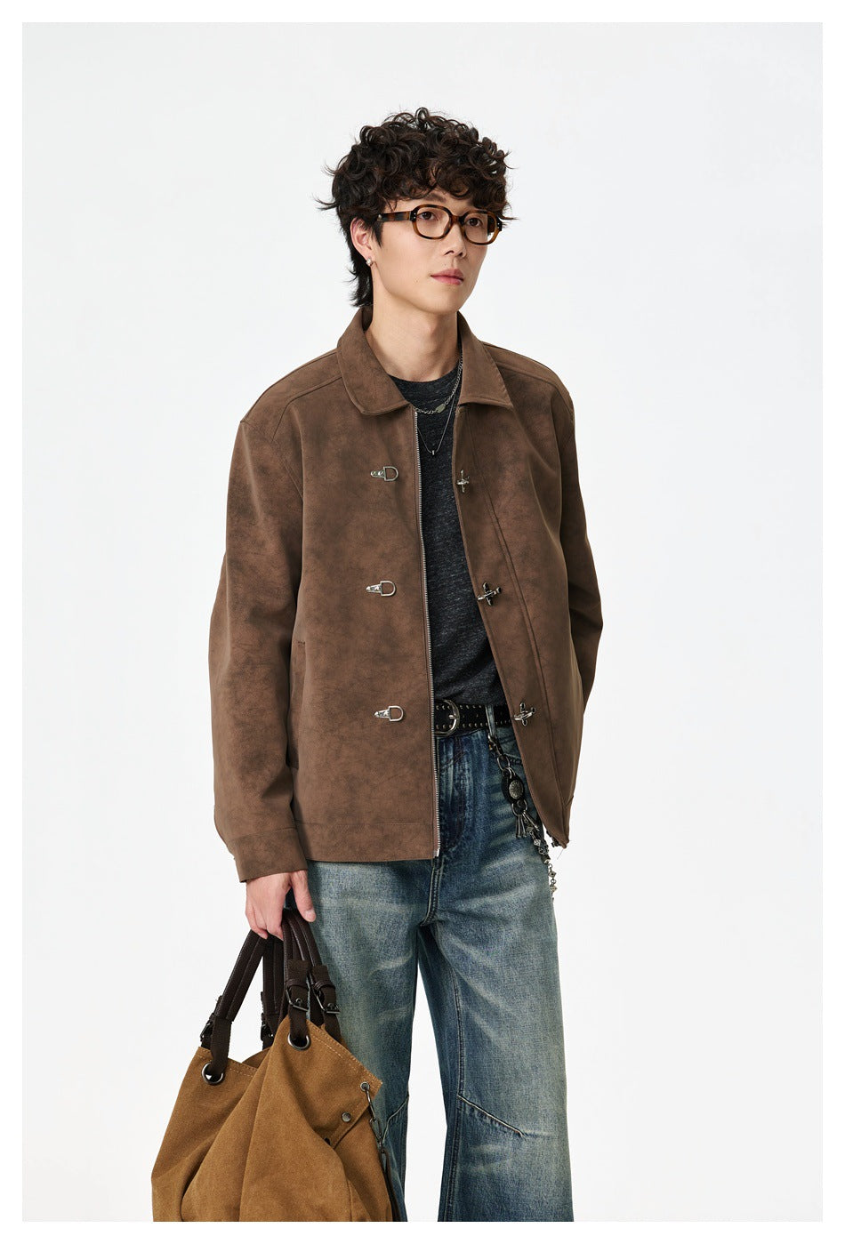 Model wearing a mottled brown jacket with silver-tone clasp closures, pictured with a tan bag.