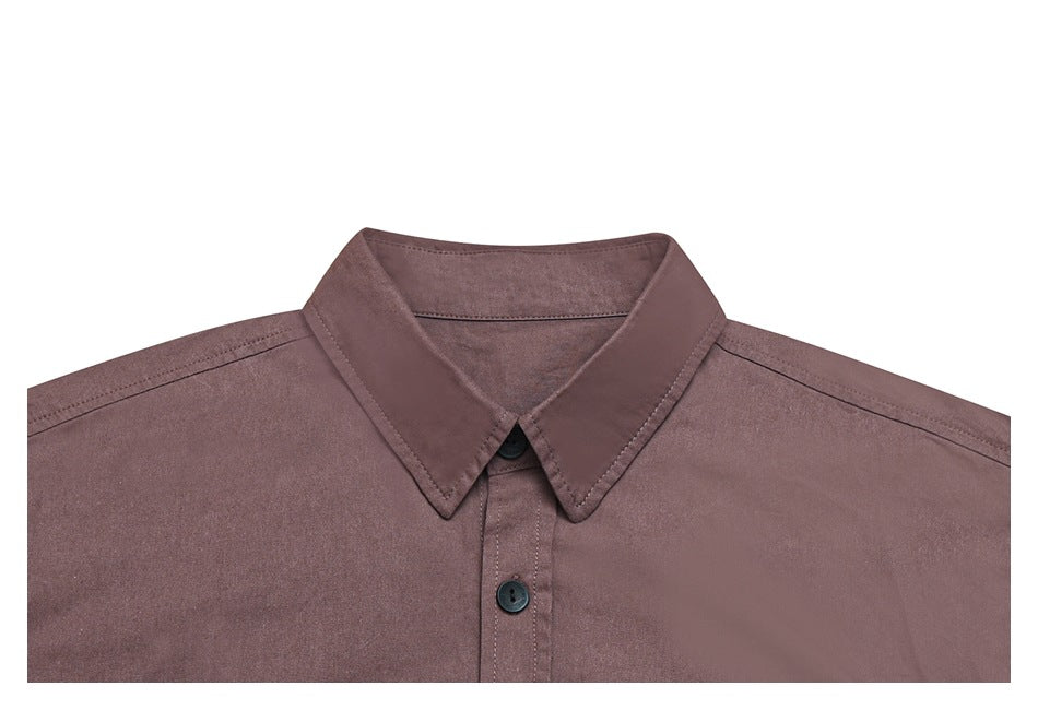 Front close-up of a mauve-brown shirt collar and button placket on a white background.