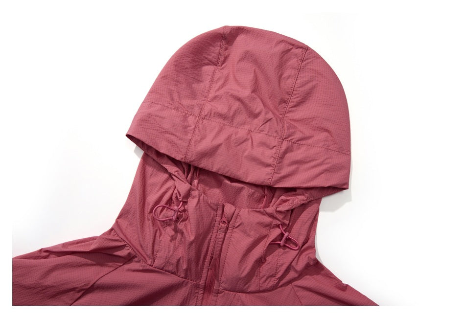 Close-up of the dusty rose jacket's hood, front zipper, and adjustable hood cords.